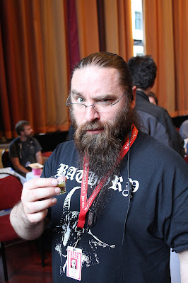 metlstorm, organizer of Kiwicon, takes a shot and looks quizzically at the camera
