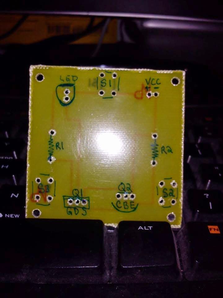Drilled board with green sharpie labeling the component holes.